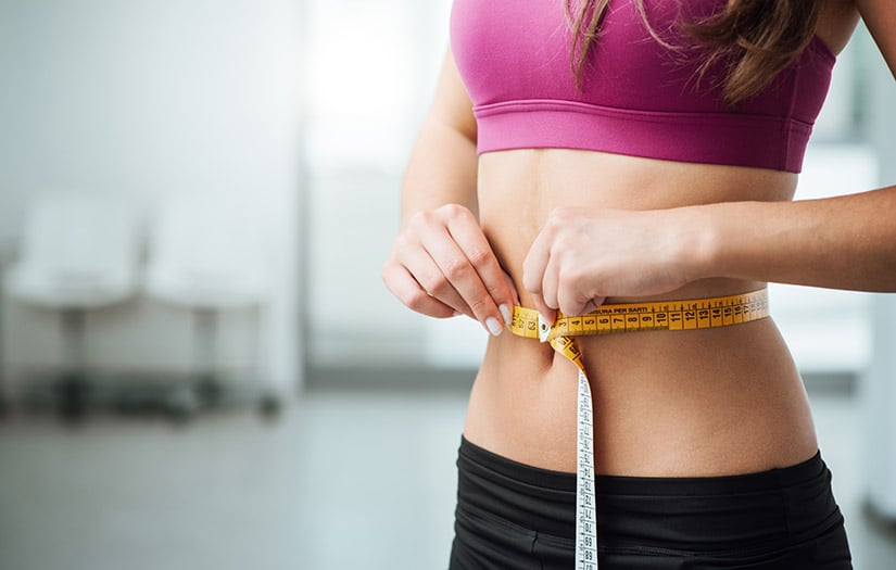 woman measuring the water weight she lost